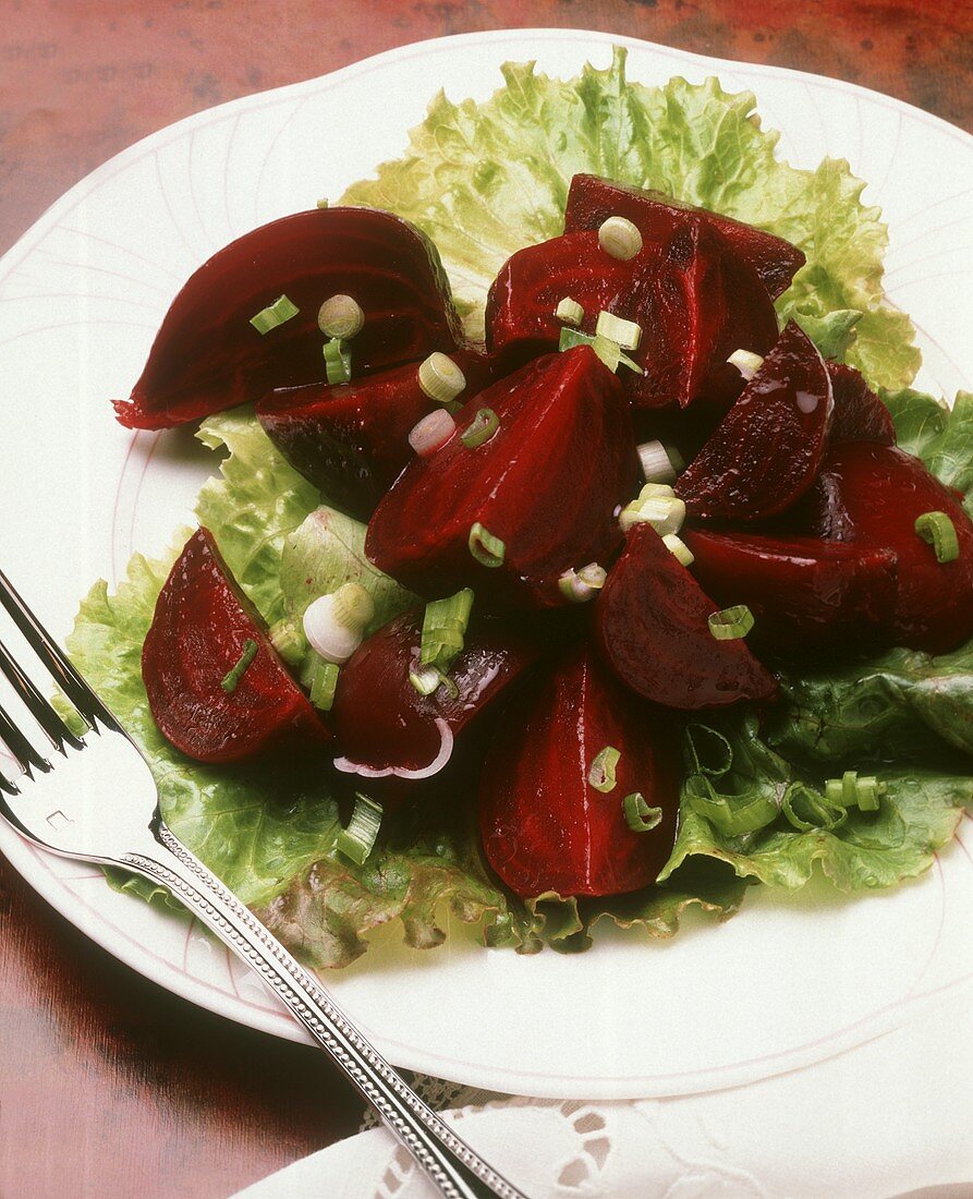Beets quartered on lettuce with scallions