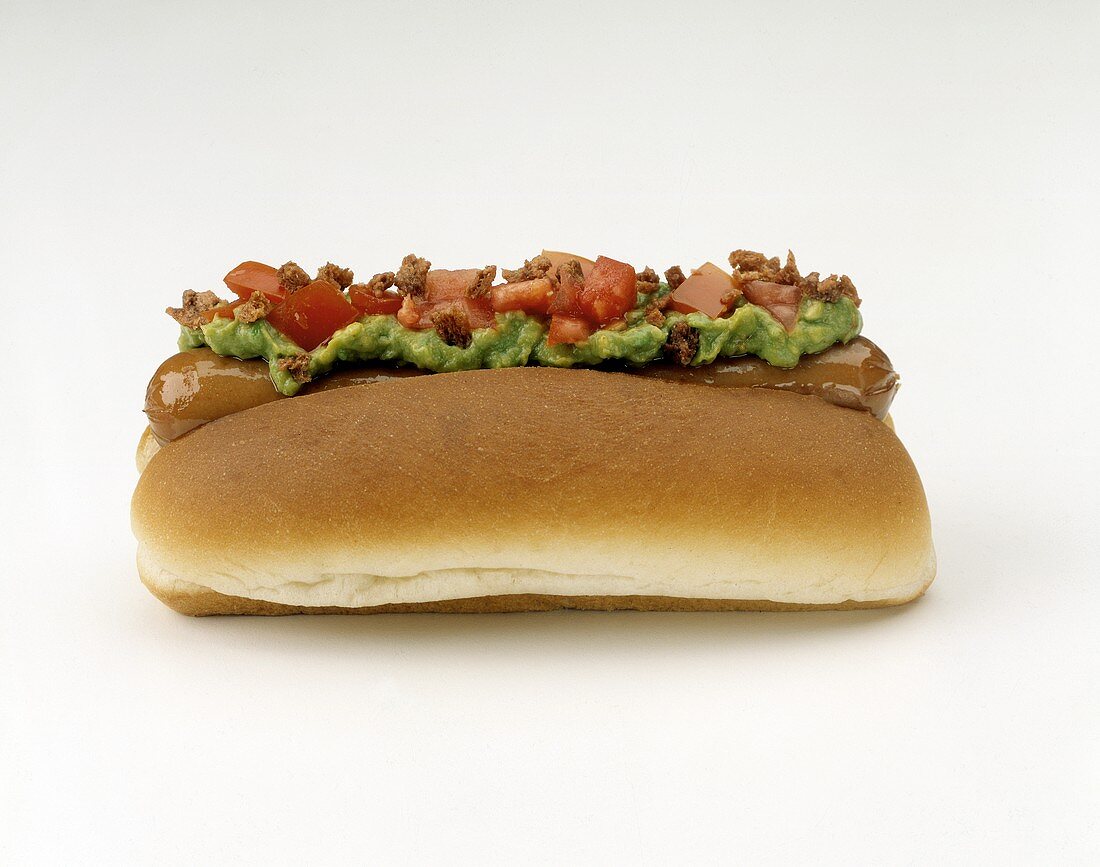 Hot Dog on Roll with Guacamole; Bacon and Tomatoes