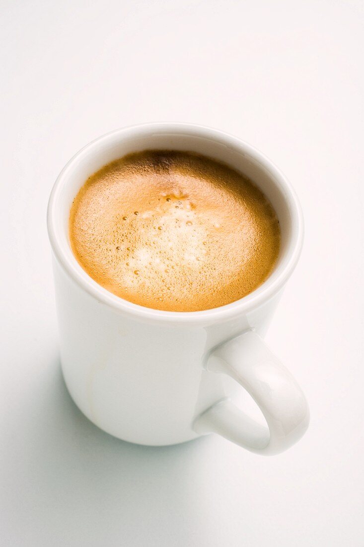 Cappuccino in a White Mug on a Saucer, White Background