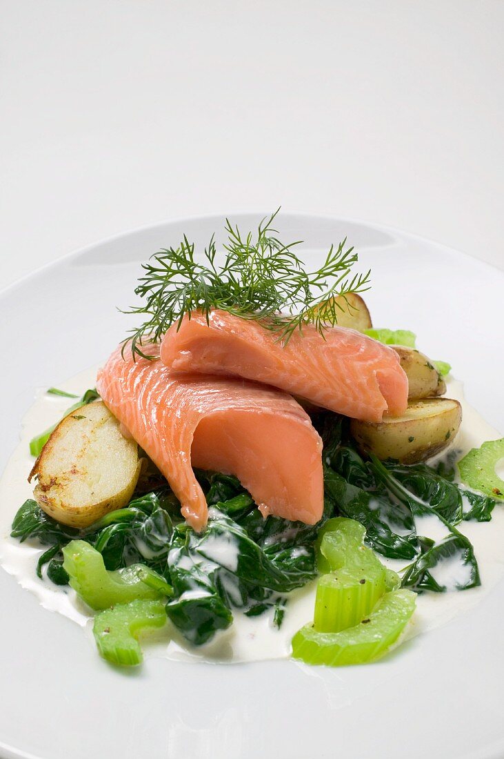 Salmon steaks with spinach, potatoes, celery and dill