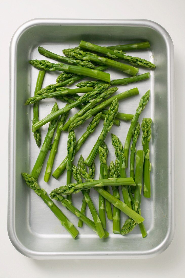 Fresh green asparagus in a roasting tin