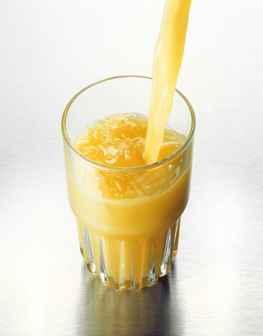 Orange Juice Pouring into a Glass