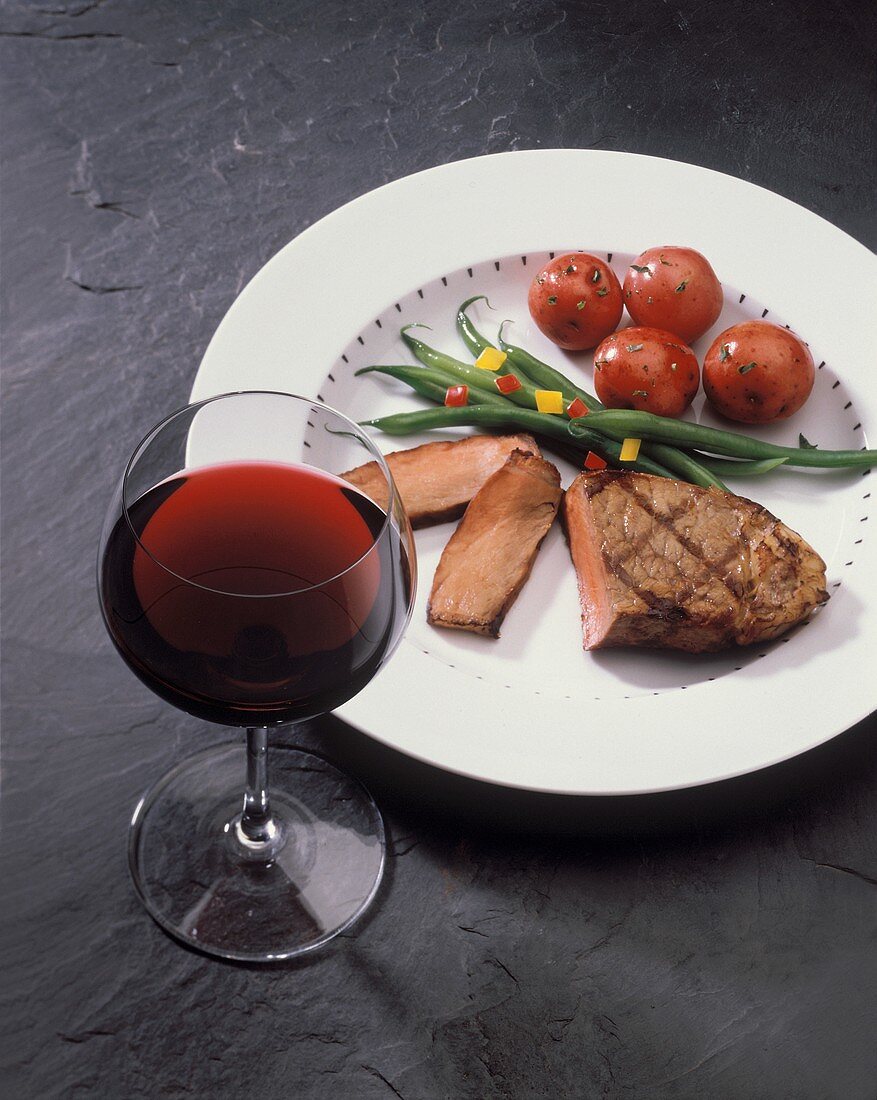 Grilled Steak on a Plate with Vegetables and Red Wine
