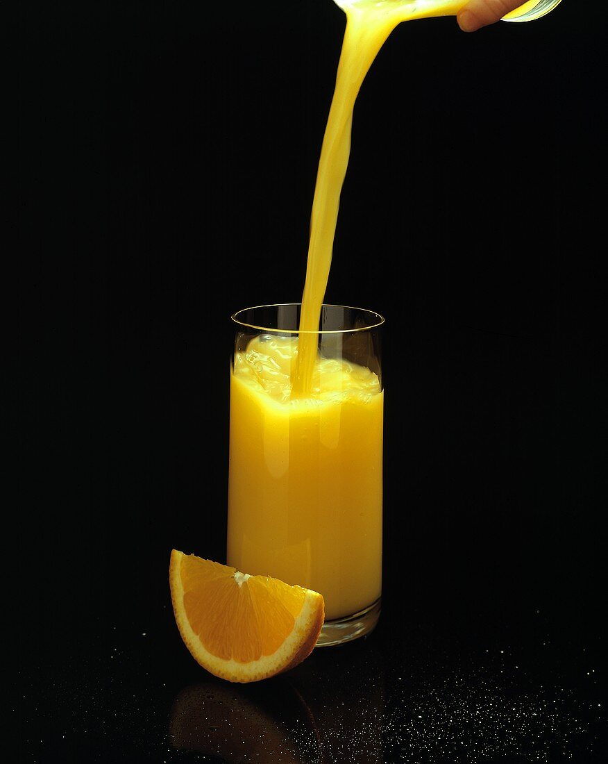 Orange Juice Pouring into a Glass