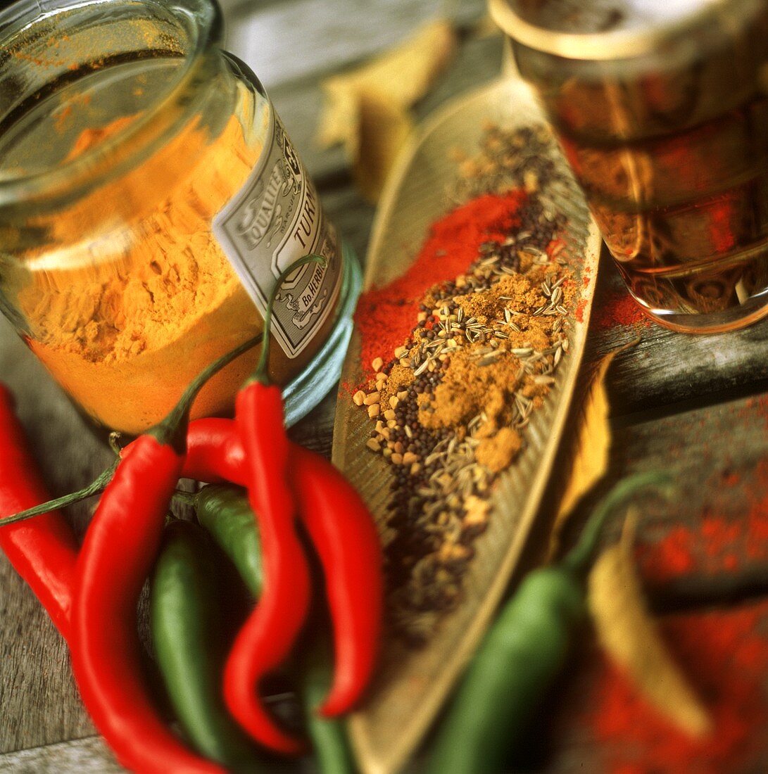 Chili Peppers with a Jar of Turmeric