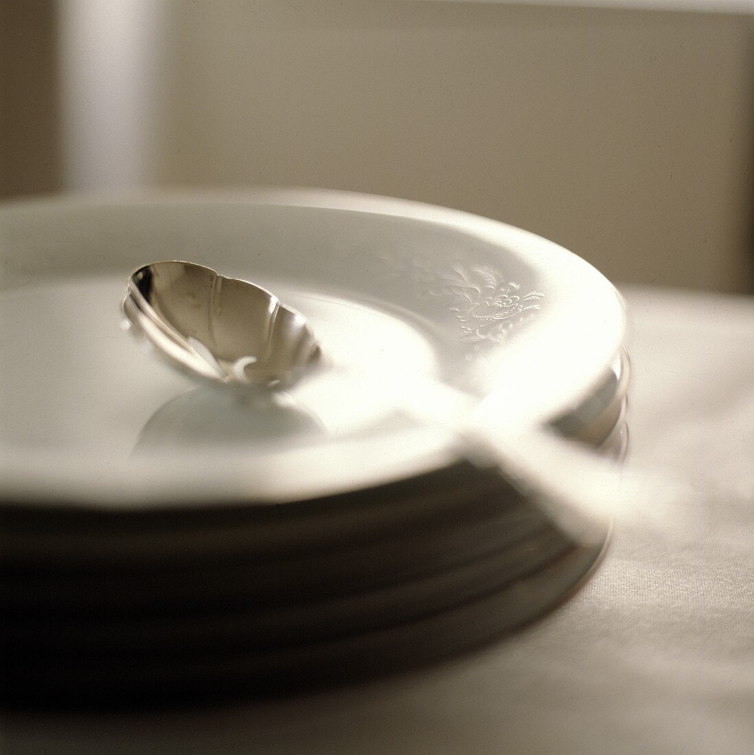 A Spoon on a Stack of Plates