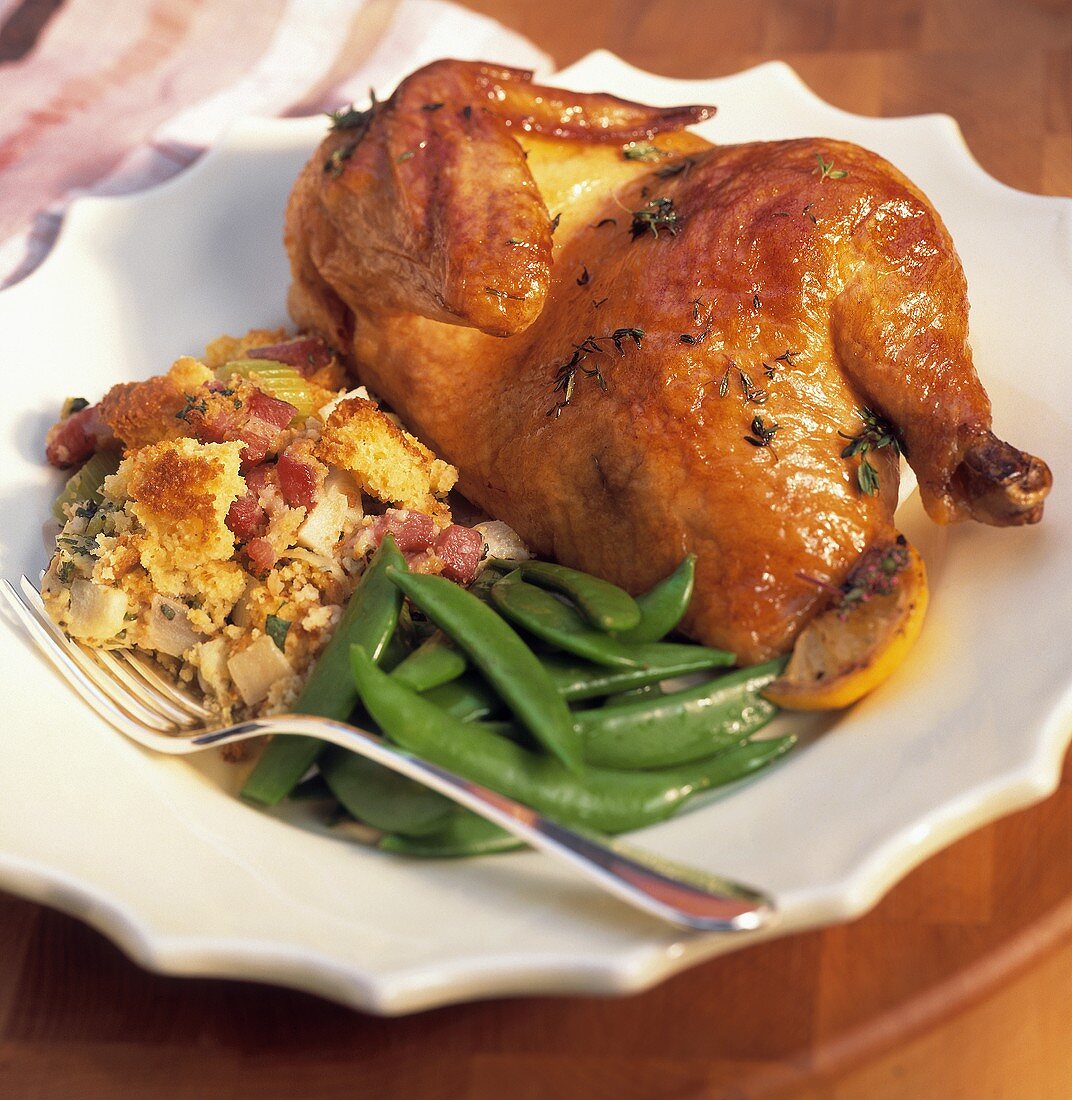 Half roast chicken with stuffing and peas