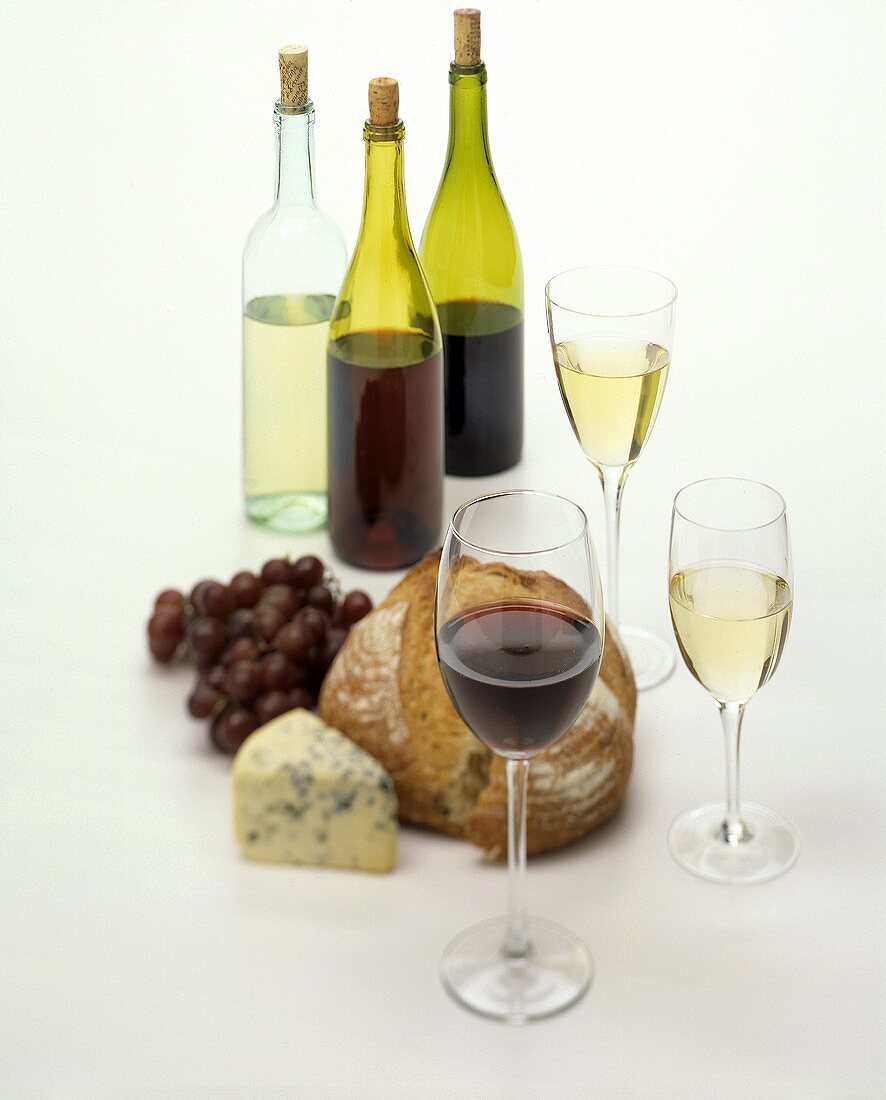 Still life with wine, bread, cheese and grapes