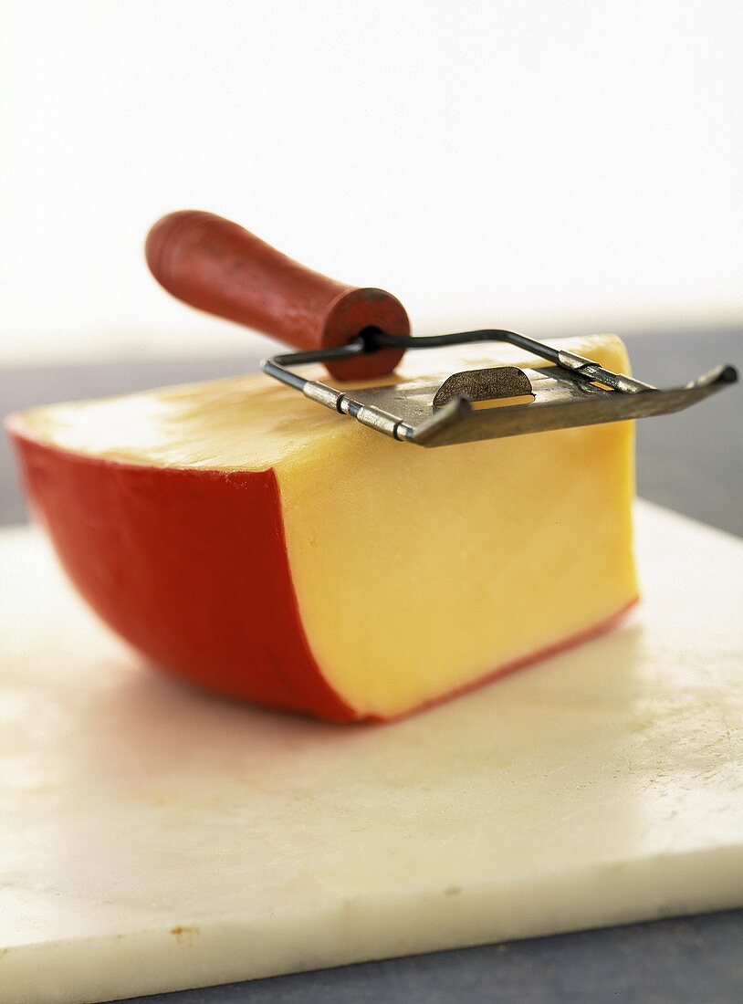 A Wedge of Gouda Cheese with Slicer