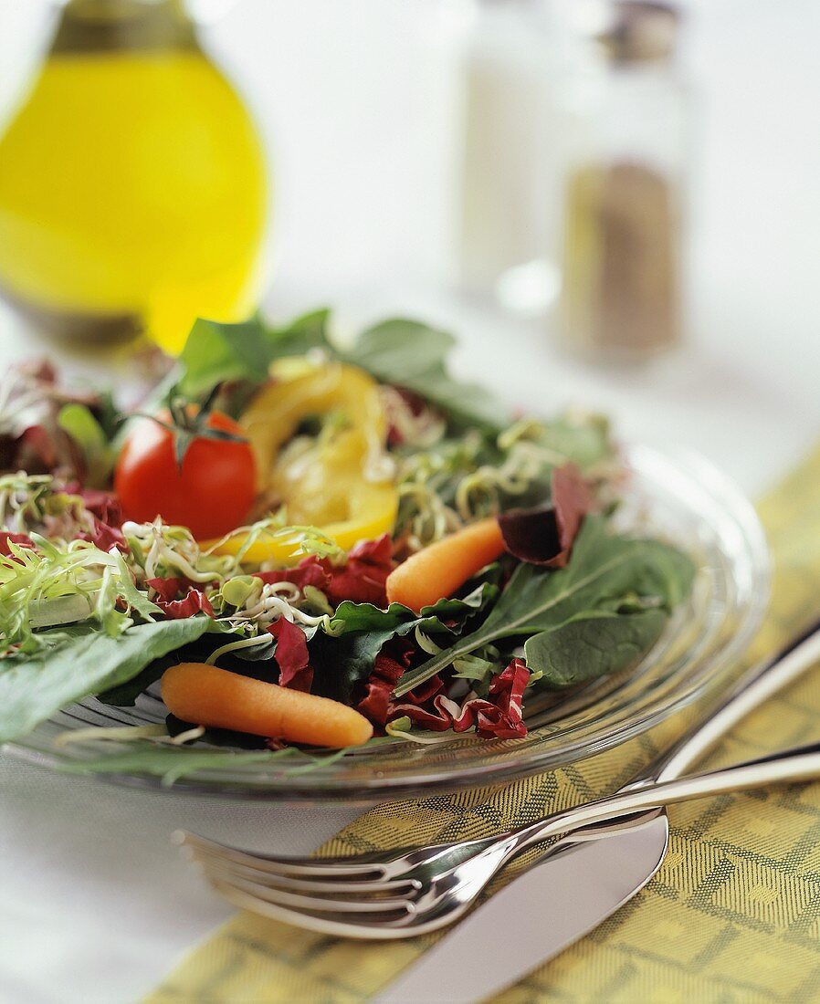 Salad leaves with vegetables; olive oil