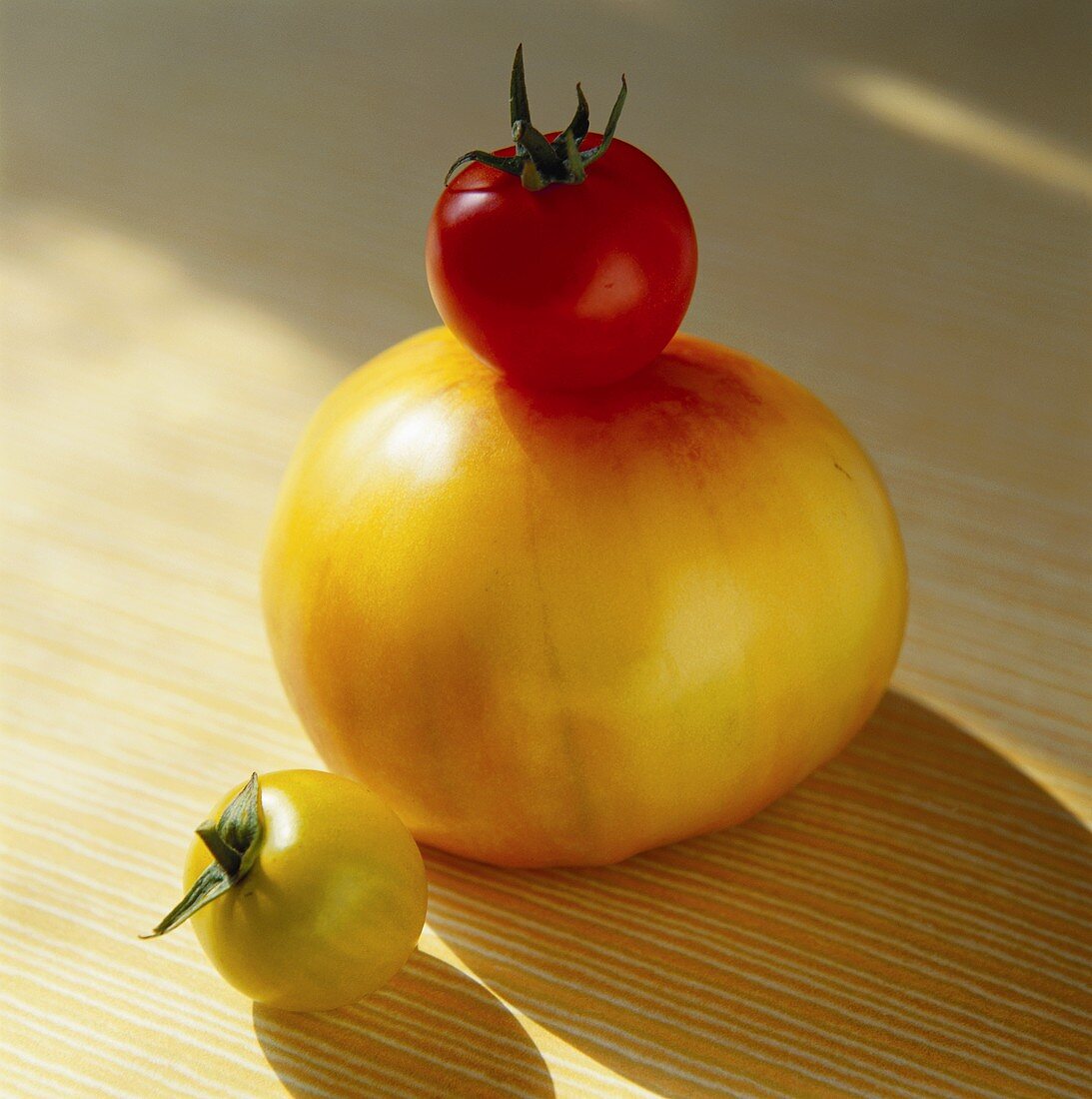 Two Yellow and One Red Tomato