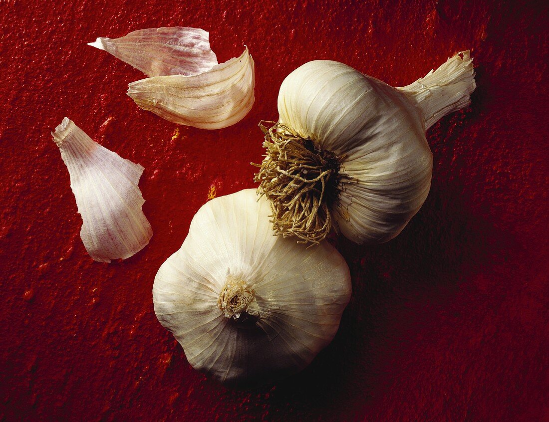 Garlic Bulbs on Red Background