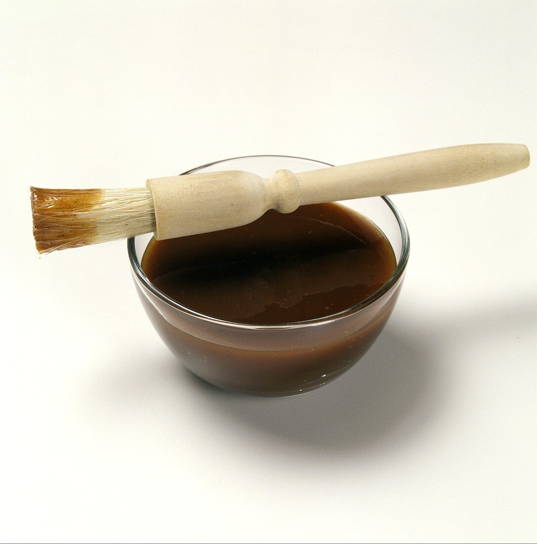Barbeque Sauce in a Glass Dish with a Brush