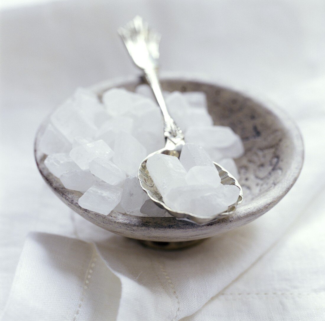 Sugar Crystals in a Clay Bowl and on a Spoon