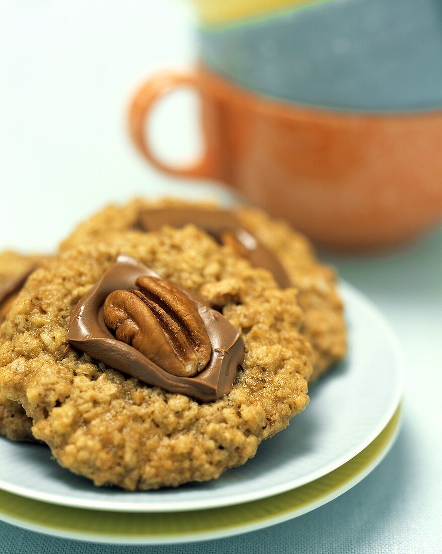 An Oatmeal Cookie Topped with Chocolate and a Walnut