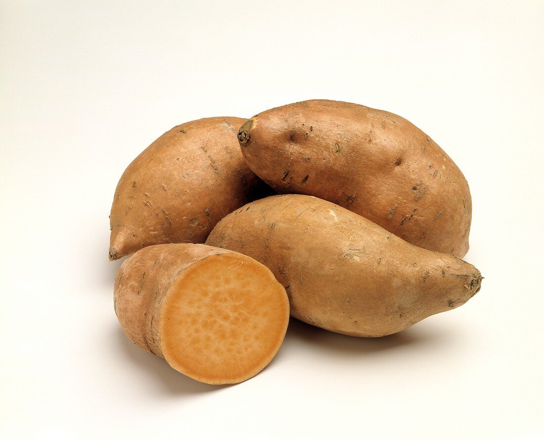 Sweet Potatoes in a Pile with One Cut in Half