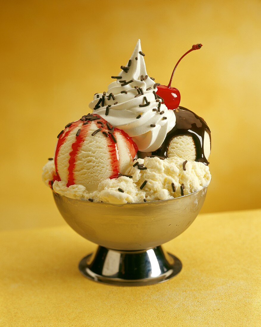 Hot Fudge Sundae with Vanilla Ice Cream, Berry Topping, Sprinkles and a Cherry