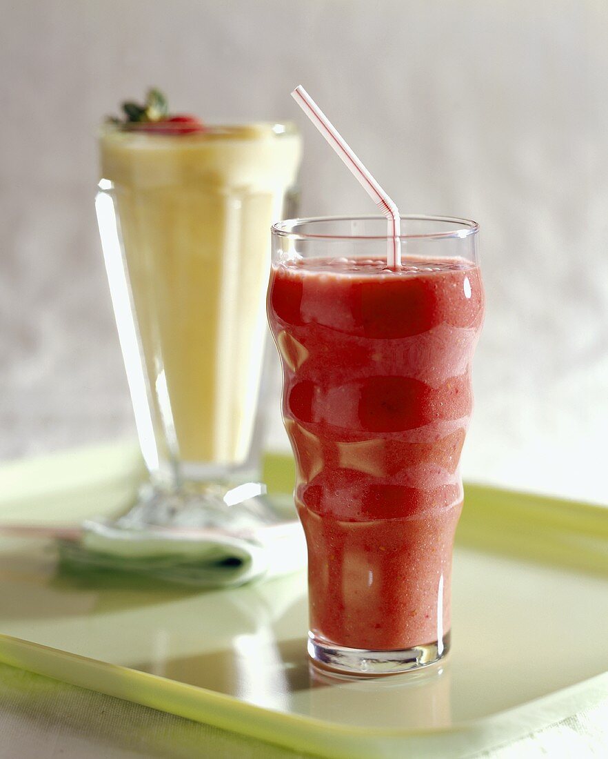 Strawberry and Banana smoothies on Green Tray with Fruit Garnish