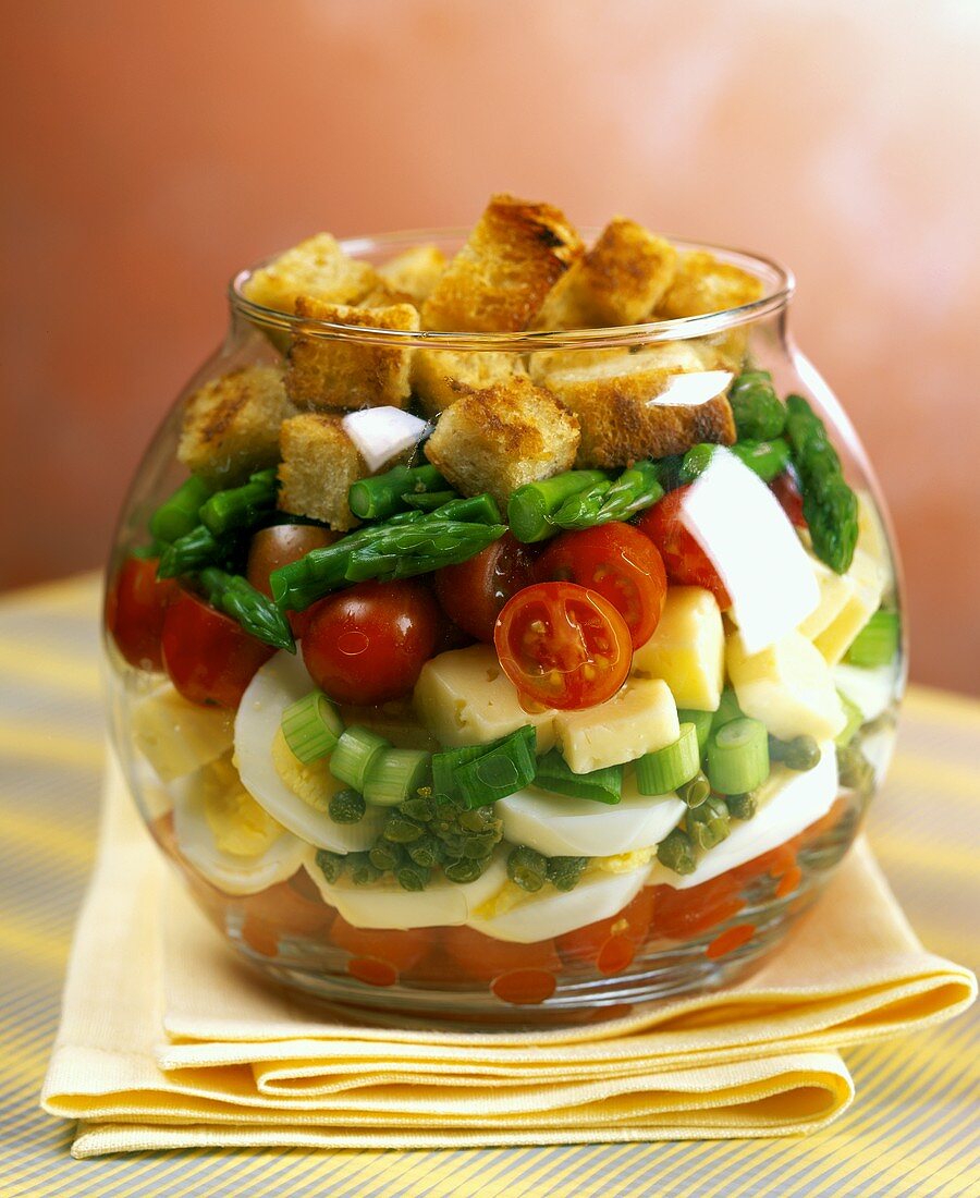Vegetable salad with cheese, egg & croutons, layered in glass