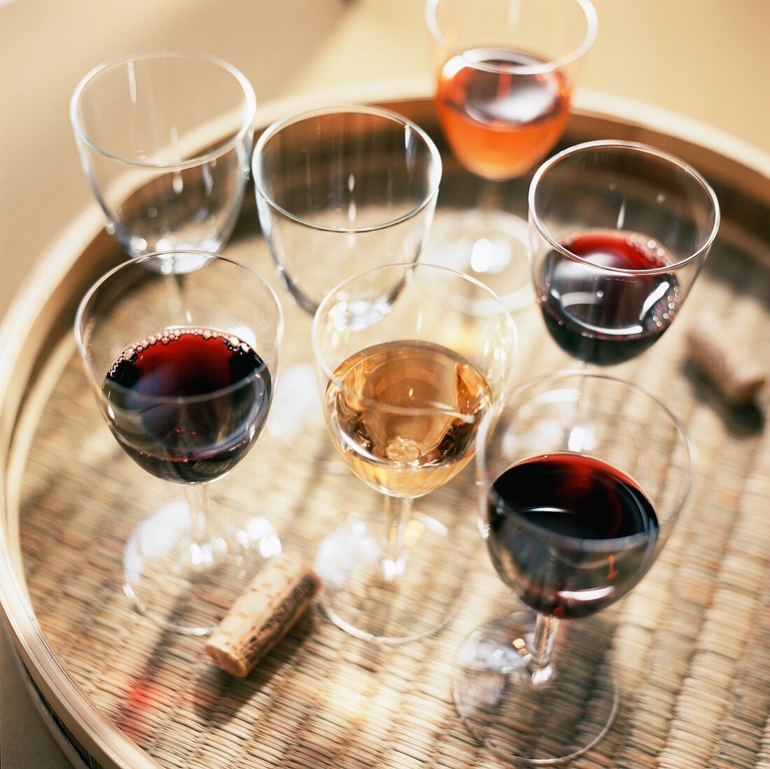 Assorted Glasses of Wine on a Woven Tray; Cork