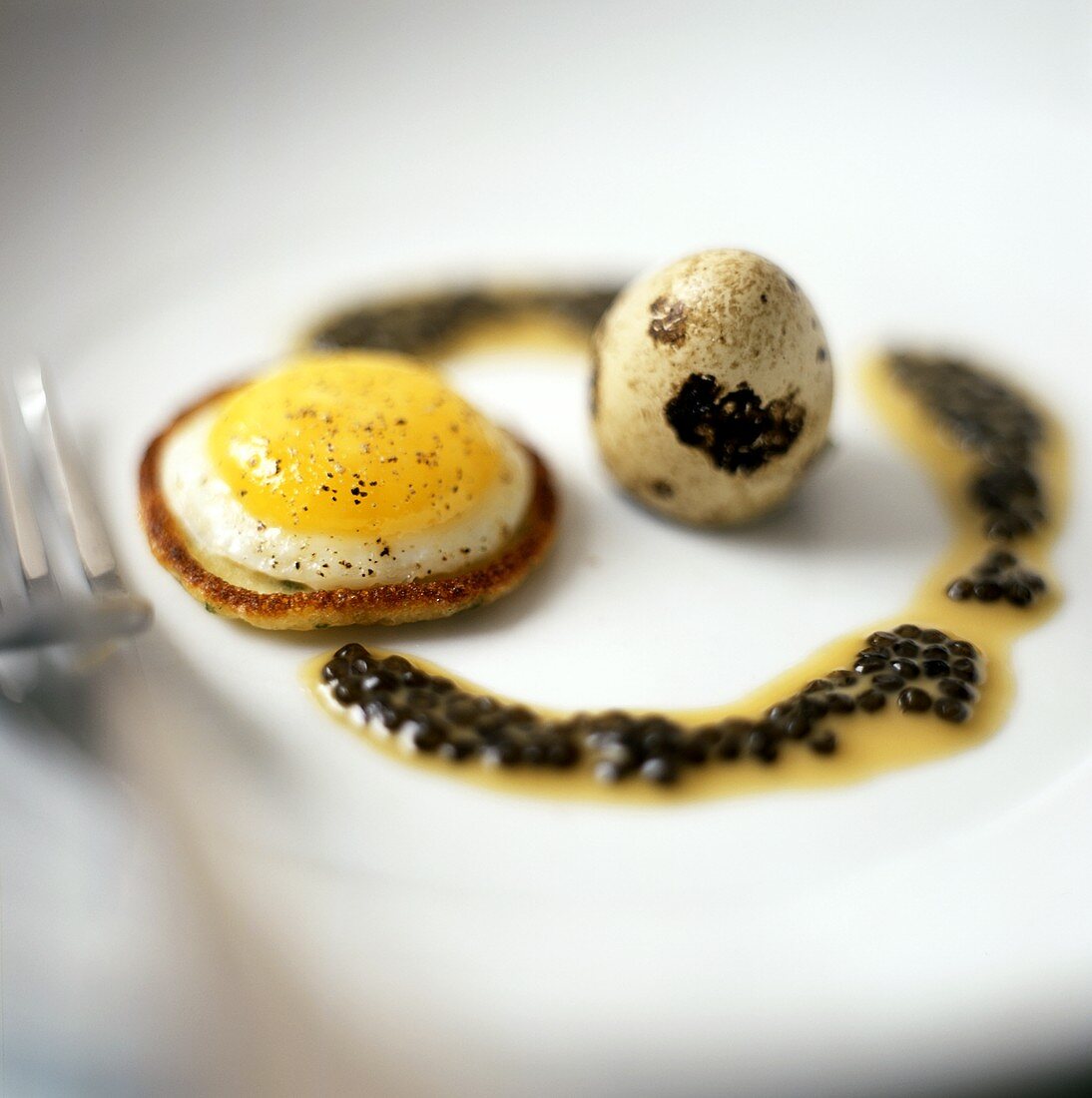Quail's egg on mini-pancake with pepper sauce