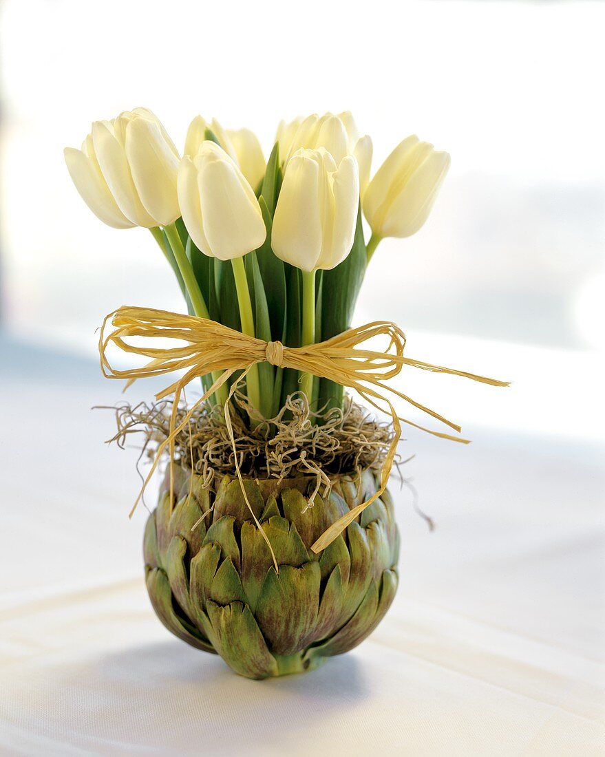 White tulips in artichoke vase