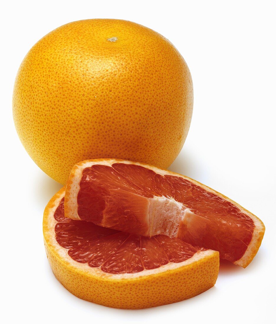 A Whole Red Grapefruit with Slices