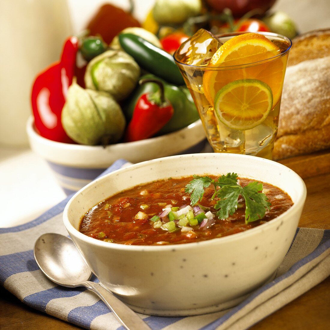 Gazpacho in soup bowl; ingredients; bread