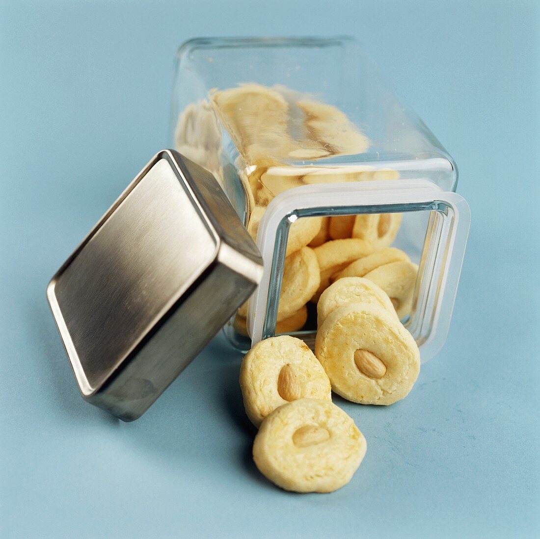 Almond Shortbread Cookies Spilling From Glass Canister