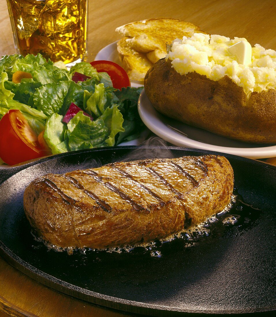 Beef steak with baked potato and salad