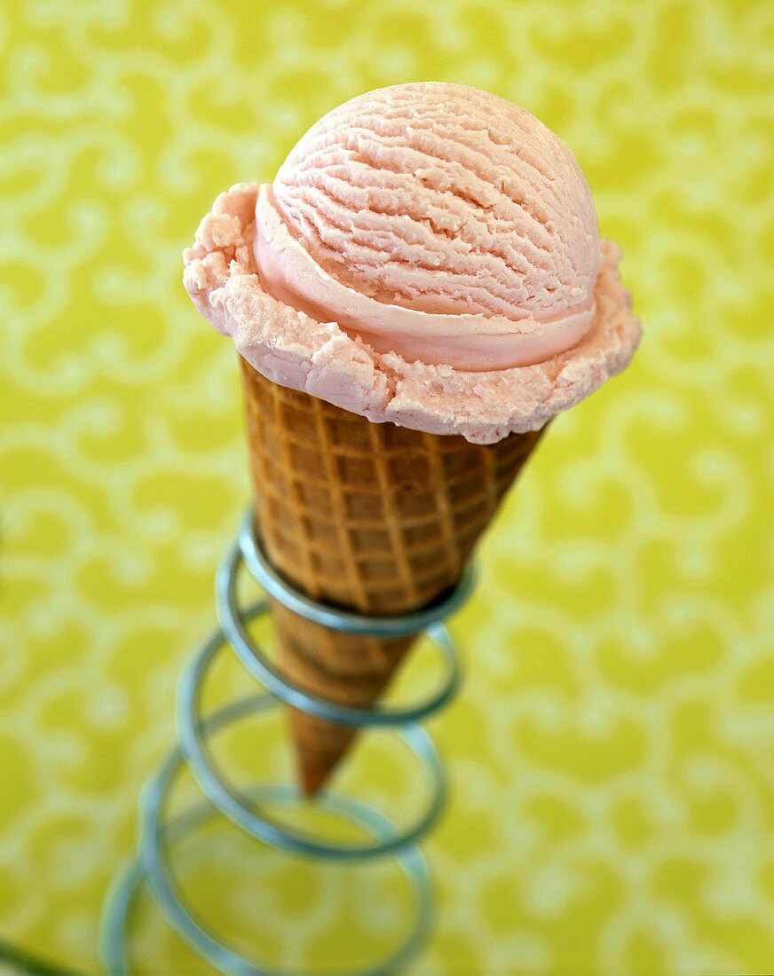 Strawberry ice cream cone in ice cream cone holder