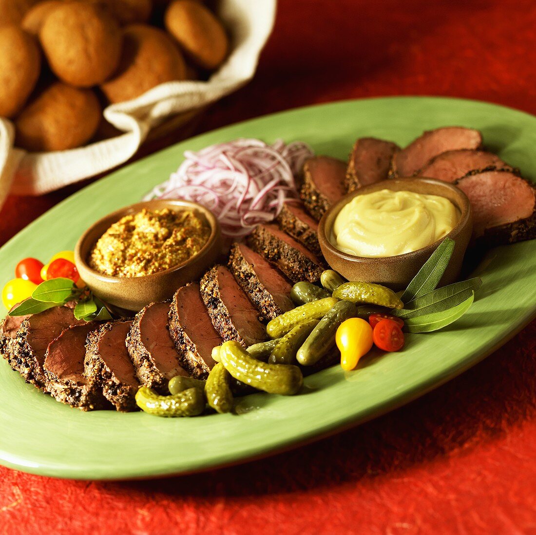 Sliced Beef Tenderloin on a Platter with Remoulade and Mustard Sauces