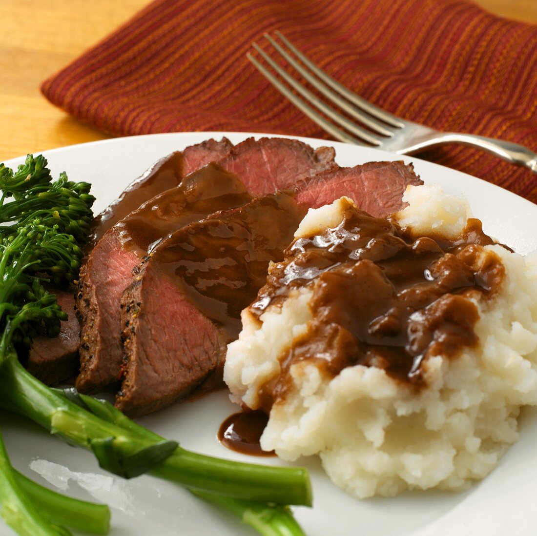Sliced Roast Beef with Mashed Potatoes and Gravy; Broccolini