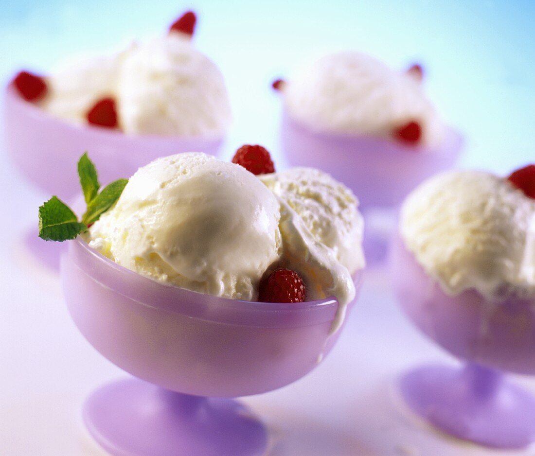 Four Bowls of Vanilla Ice Cream with Raspberries