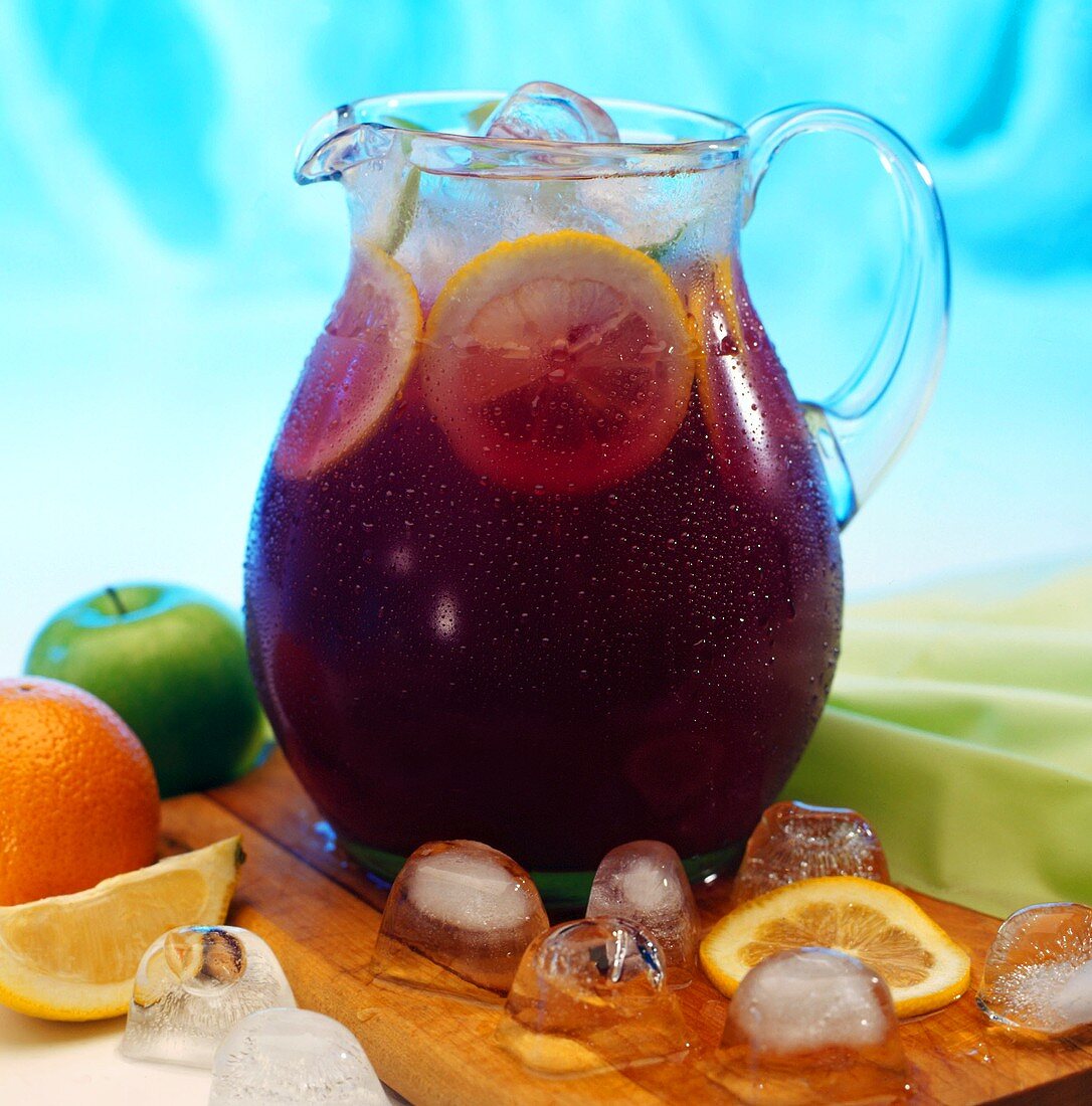 Fruit punch with ice cubes in glass jug