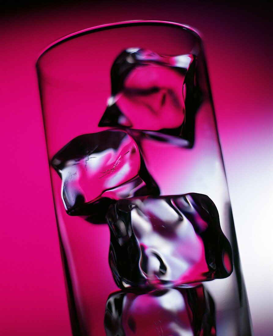 Ice cubes in a glass in purple light