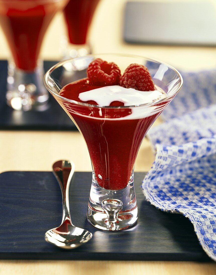 Raspberry pudding with cream in glass