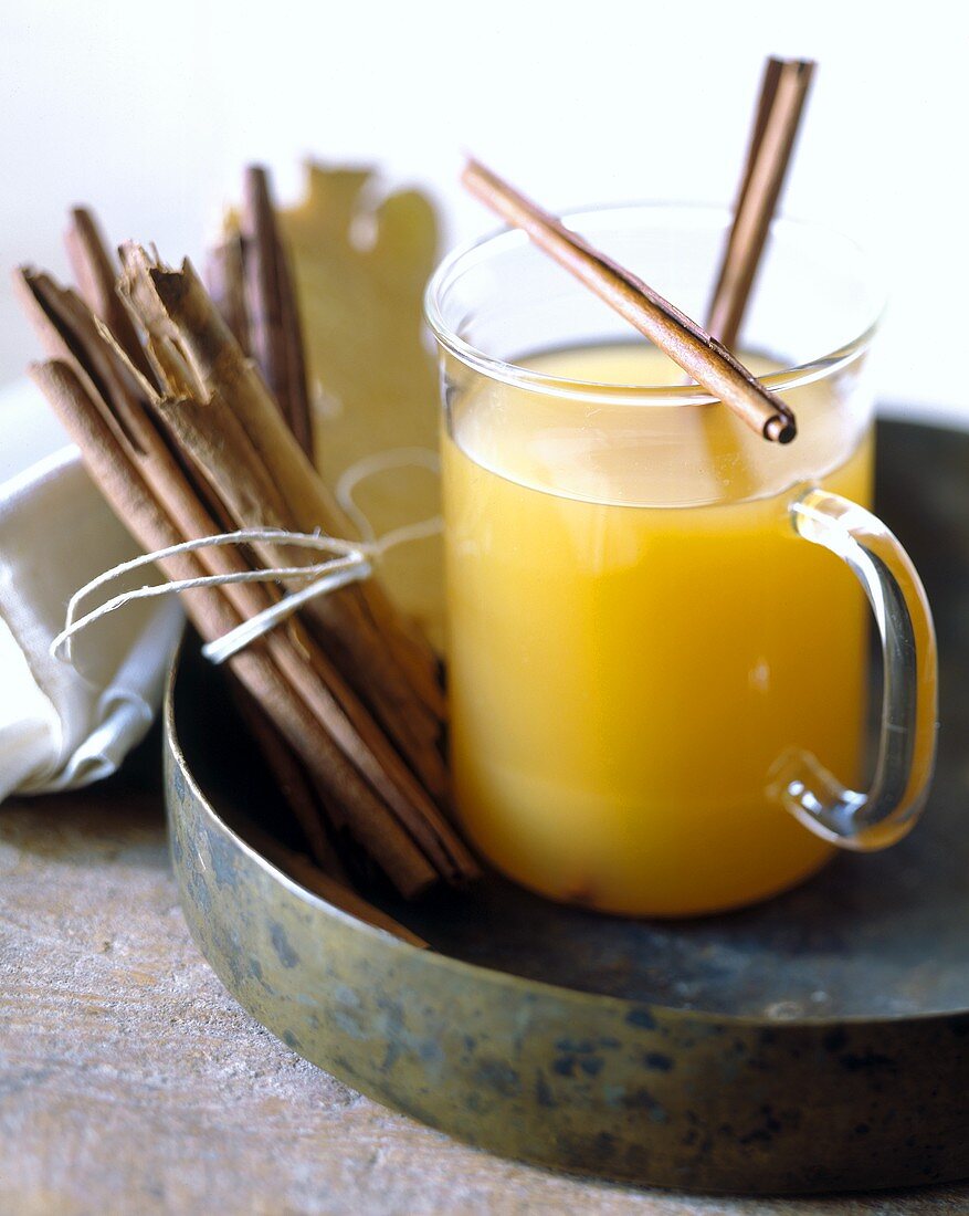 Pineapple and ginger punch with cinnamon sticks