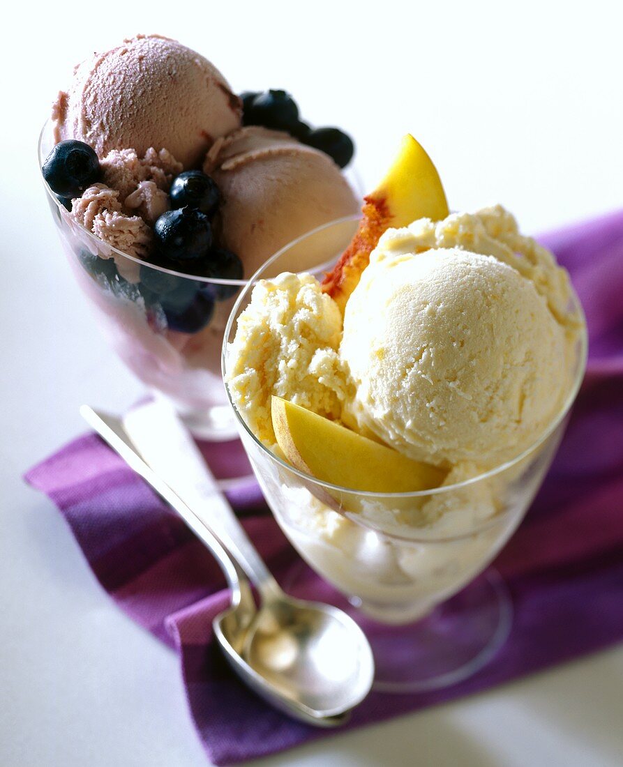 Blueberry ice cream and peach ice cream in glasses