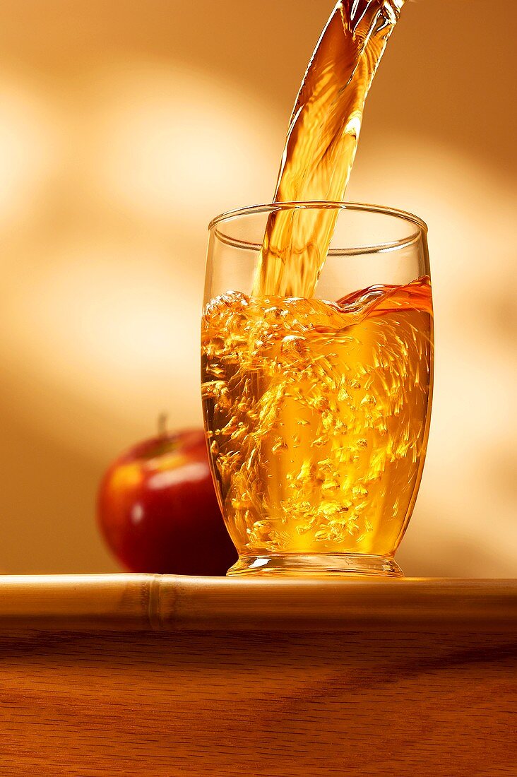 Apple juice being poured into a glass