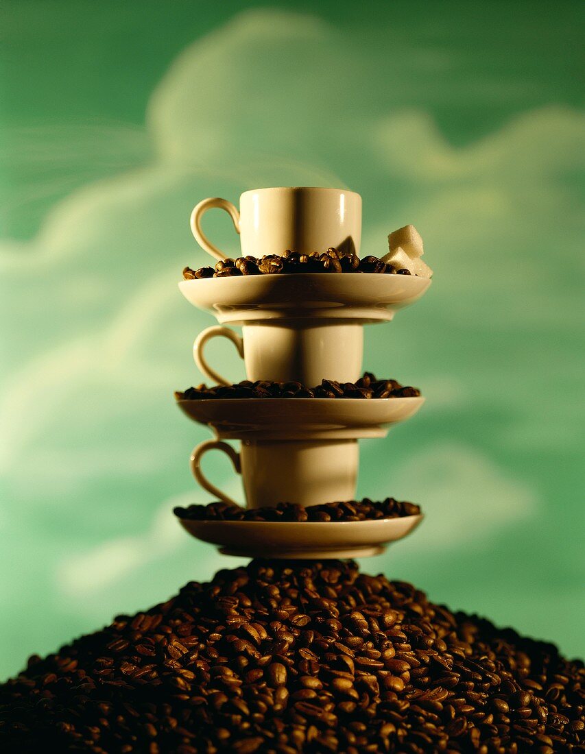 Pile of coffee cups on a heap of coffee beans