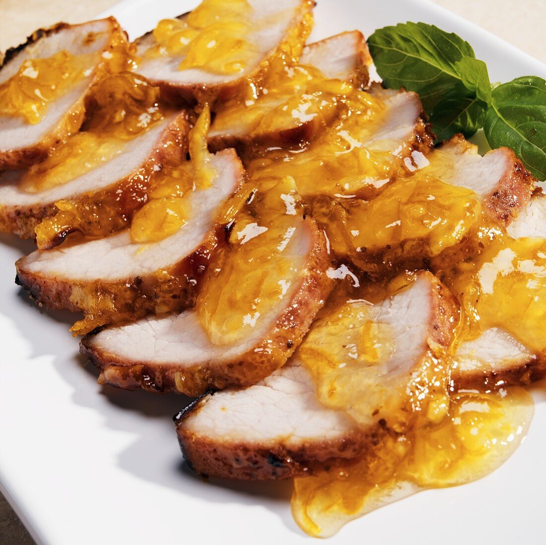Sliced Roast Pork Loin with Orange Glaze on a Platter
