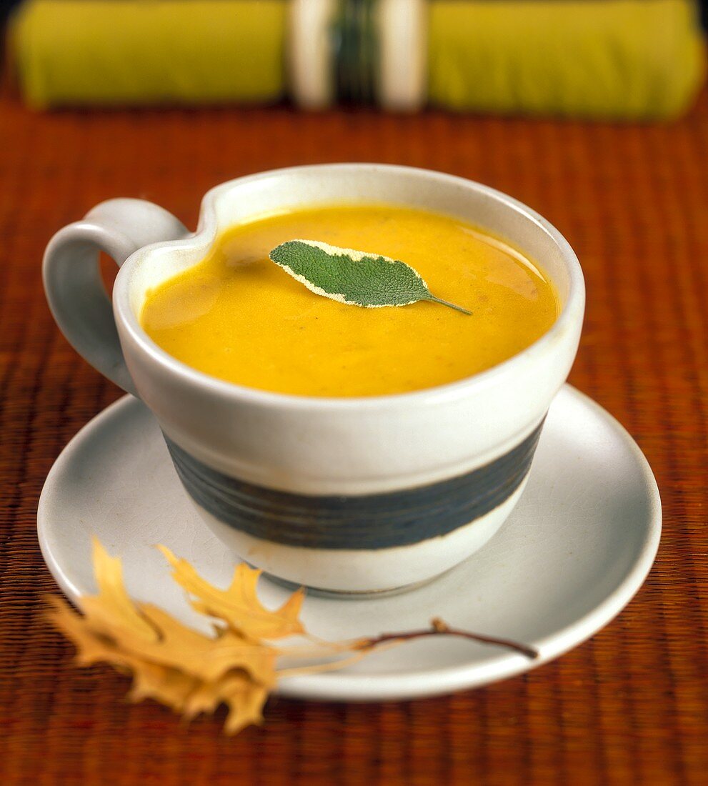 A Cup of Pumpkin Soup with a Sage Leaf