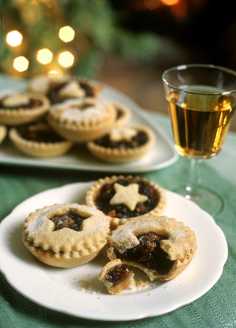 Several mince tartlets with a glass of wine