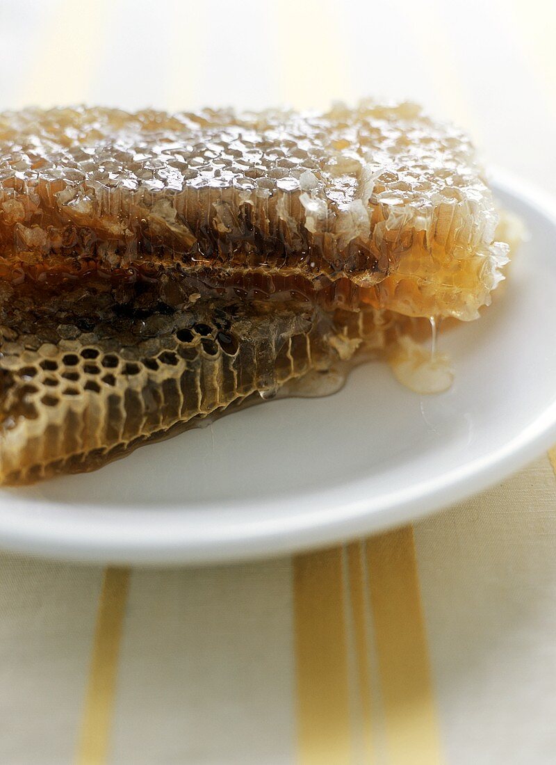Honeycomb Dripping with Honey on a Plate