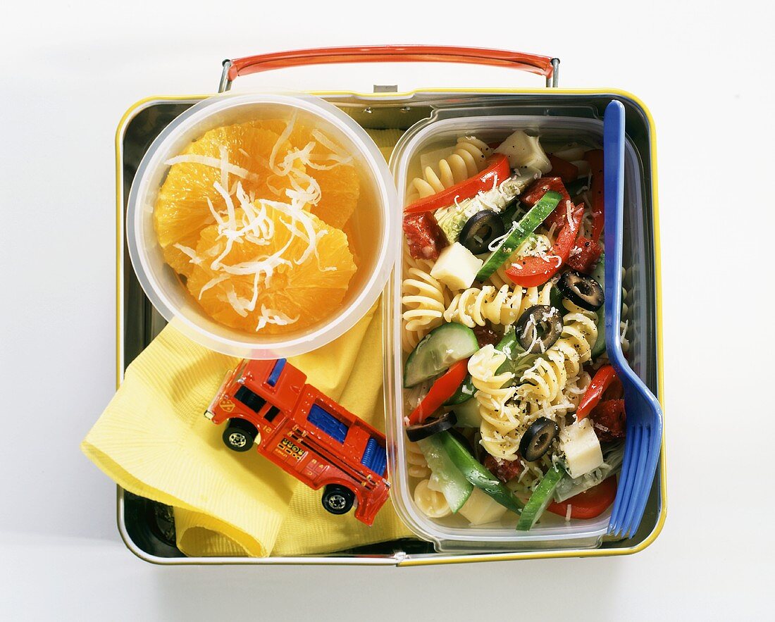 A Child's Lunchbox with Pasta Salad and Sliced Oranges