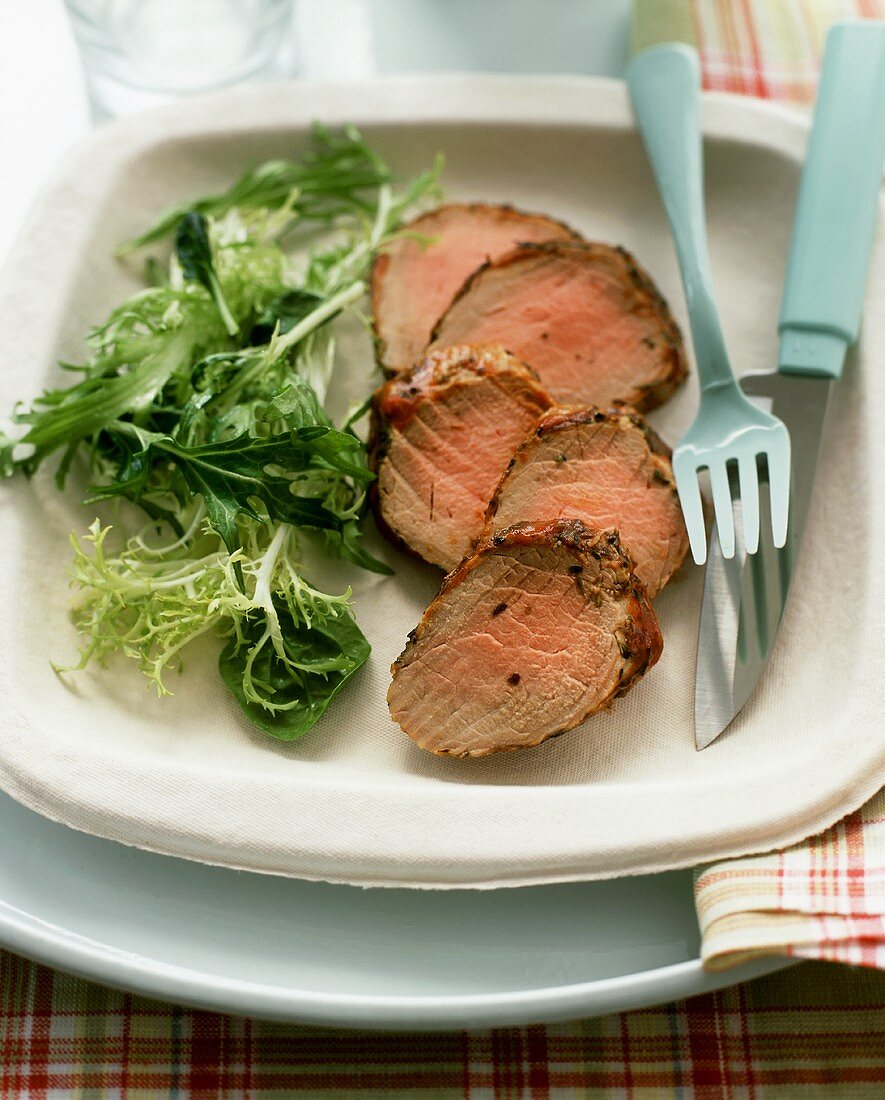 Cold pork fillet, sliced, with salad garnish