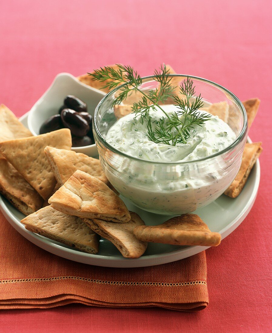 Tzatziki with pita triangles and olives