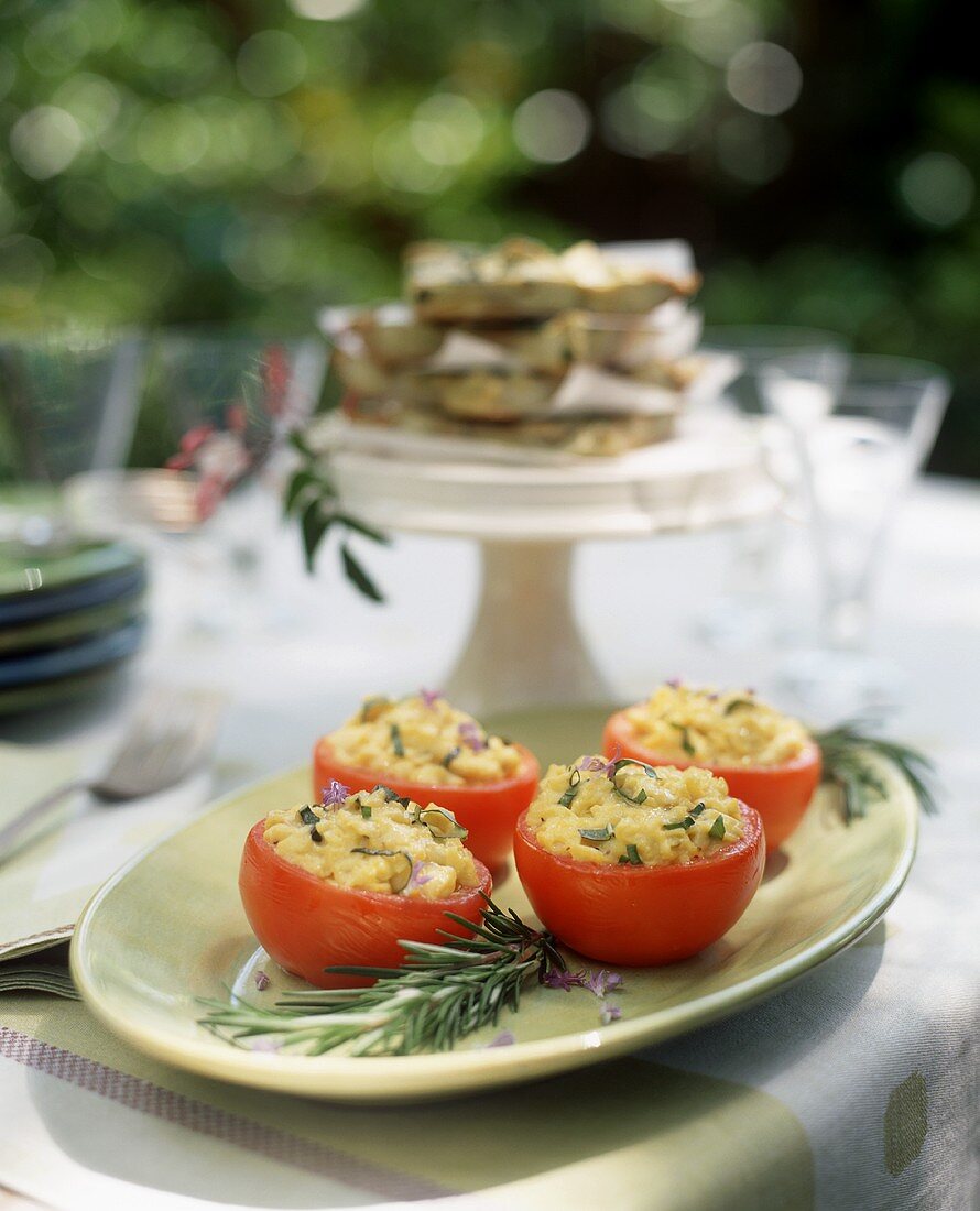 Tomaten mit Rühreifüllung auf Tisch im Freien