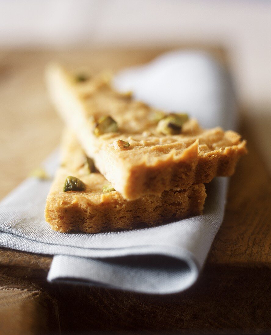 Two Pieces of Pistachio Torte on a Blue Napkin